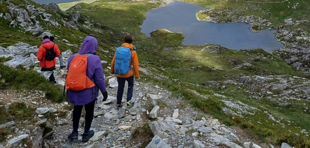 Hikers with Black Girls Hike walk down a mountain towards a couple of lakes