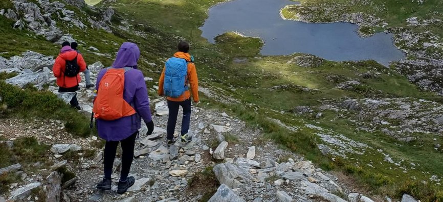 Hikers with Black Girls Hike walk down a mountain towards a couple of lakes