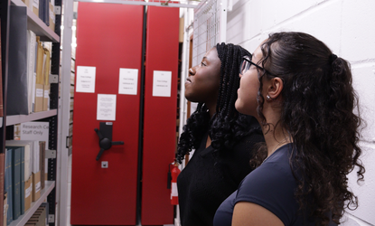 Serendipity Institute for Black Arts and Heritage-young women looking at archival collection