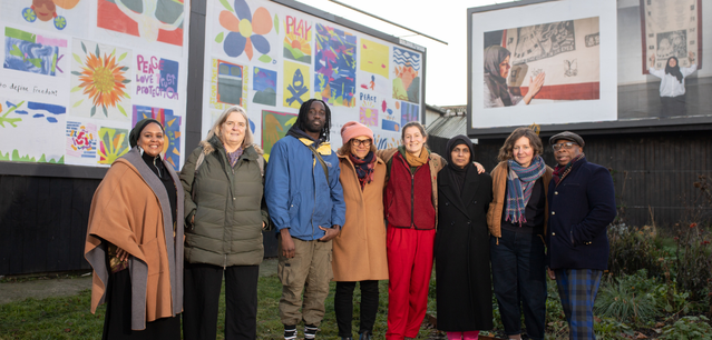Artist and Facilitators in front of Trinity Community Arts' outdoor exhibtion (credit Sham Ahmed)